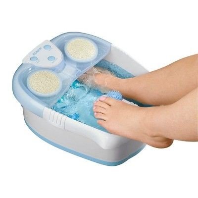 A foot soak set up on the floor with a towel underneath
