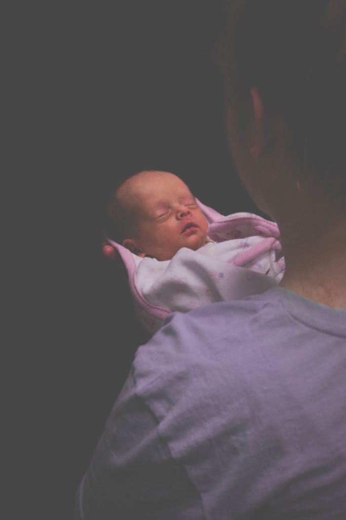 A tired mother holding her newborn